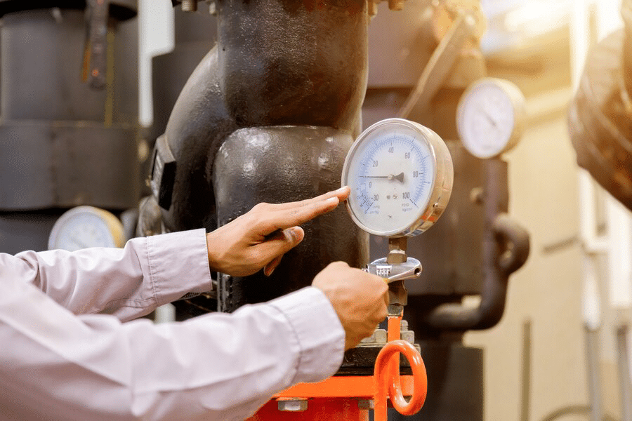 man checking the condenser water pump pressure