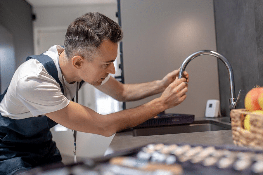 man holding the water tap faucet