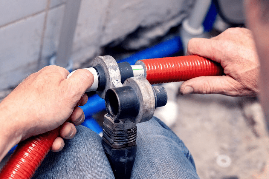 plumber holding a plastic pipes