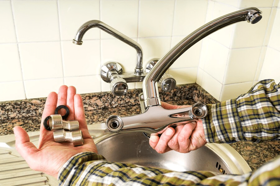 hands holding bathroom faucet