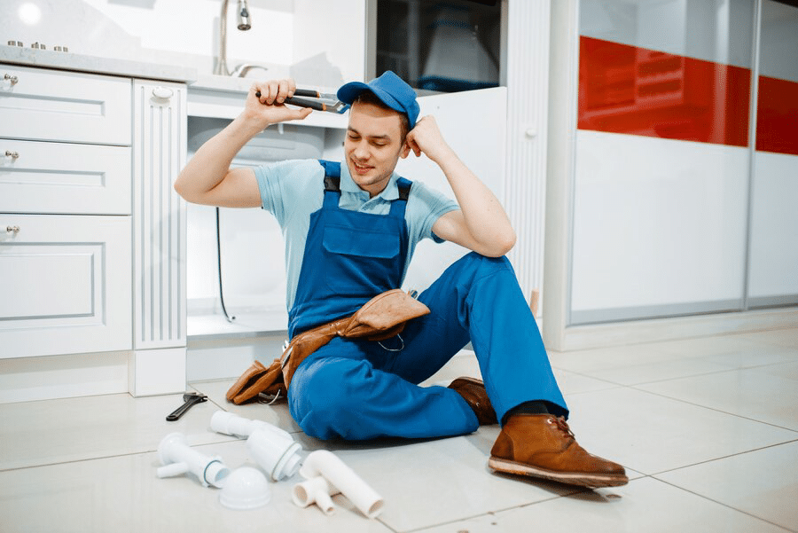 male plumber in uniform smiling