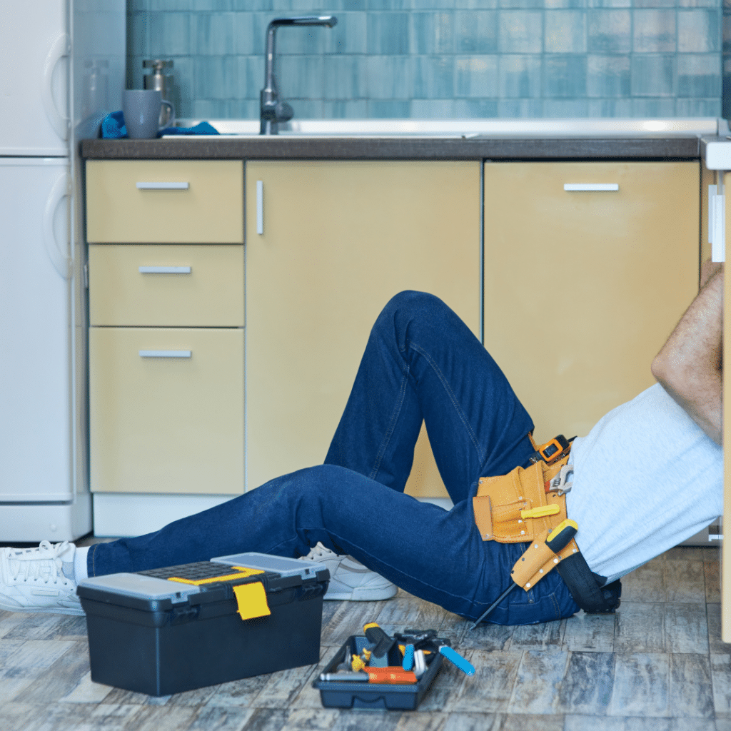 man fixing near the sink