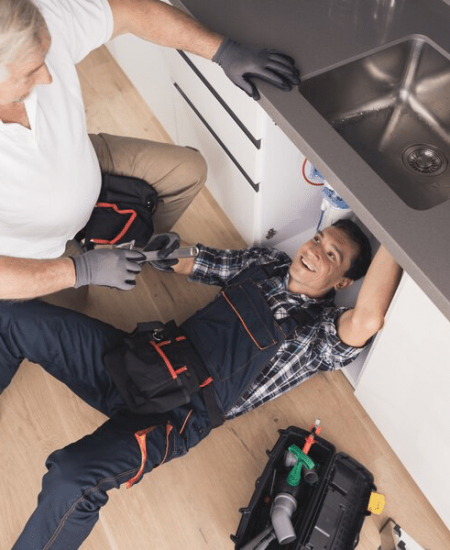 two plumbers repairing